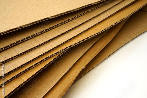 Close-up of stacked corrugated cardboard on white background.
