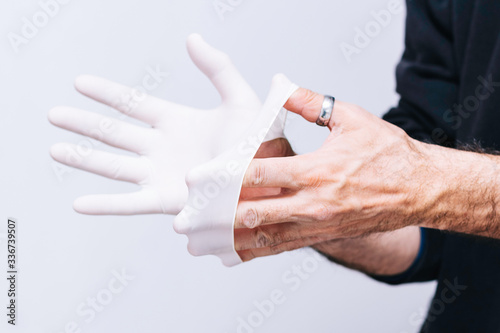 
Person taking off a latex glove correctly so as not to get infected
Conceptual hygiene, fight against covid-19, coronavirus and its impact