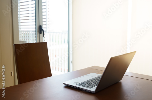Laptop on Wood Table at Home Office. © tanaonte