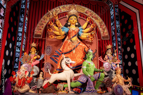 Idol of Goddess Devi Durga at a decorated puja pandal in Kolkata, West Bengal, India. Durga Puja is a popular and major religious festival of Hinduism that is celebrated throughout the world.