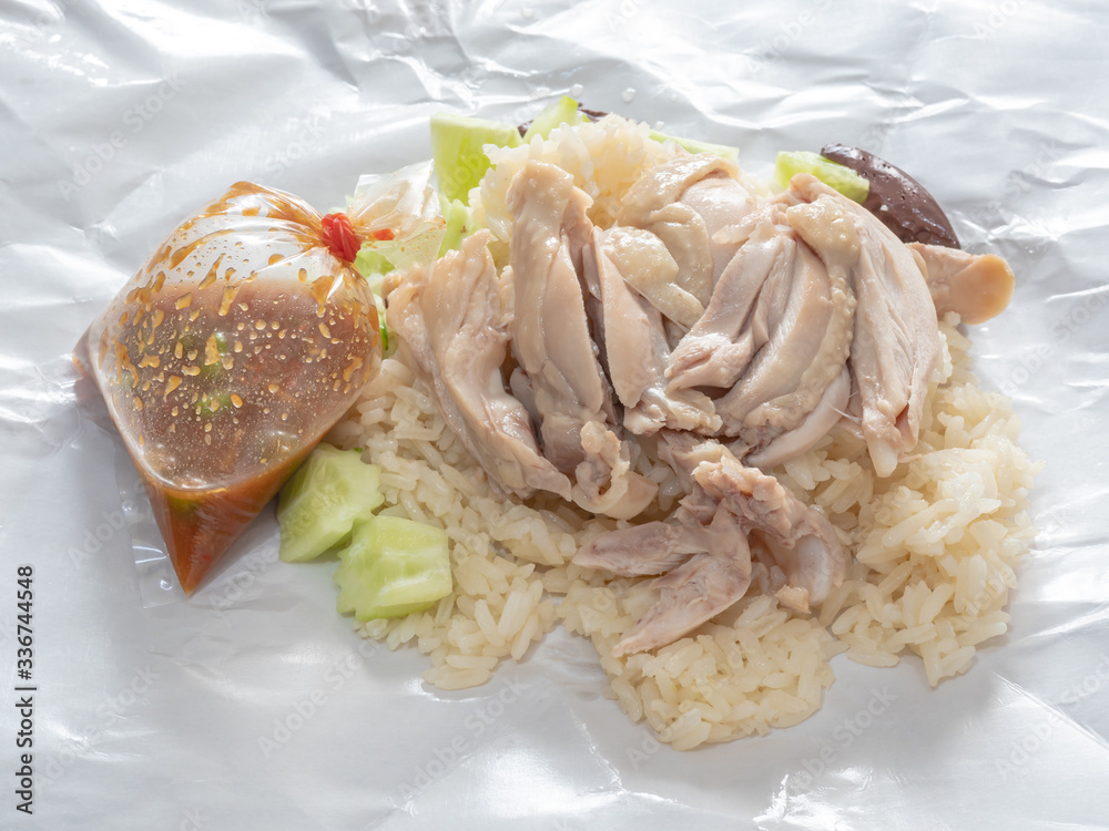 The close up of Thai chicken rice food on paper sheet. The close up of Thai chicken rice food on paper sheet.