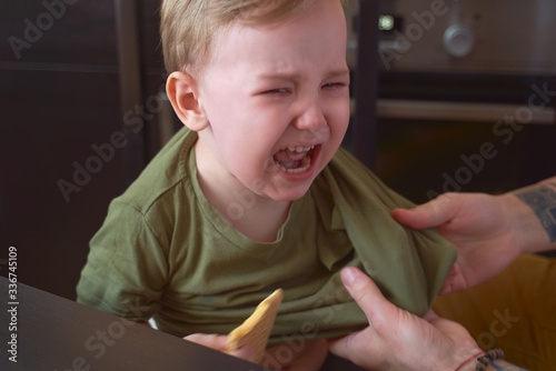 Small child bitterly bursts in tears, capricious, has bad mood, takes out brain of parents, tearfully asks to play, yells, throws tantrums. Day, kitchen. Tired of quarantine, wants to go outside.