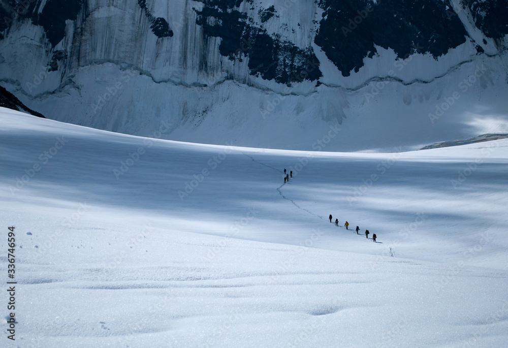 Group of alpinists cross Mensu glacier, Belukha Mountain, Altai