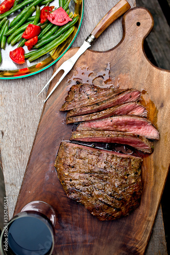Overhead view of grilled flank steak slices on cutting board