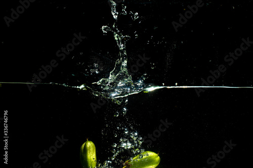 fresh starfruit water splash with black background
