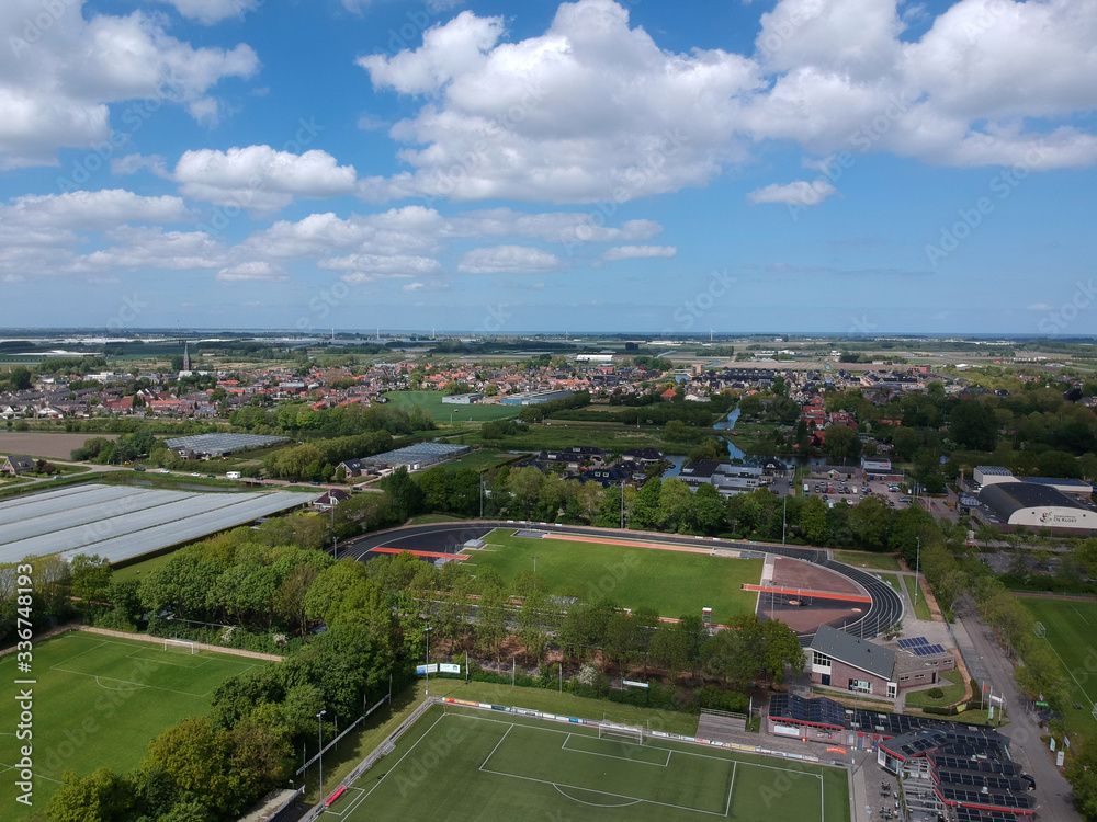  Drone Aerial view of soccer fields and the buildings of the village of Grootebroek, which is part of urban planning. Photo make with a drone 