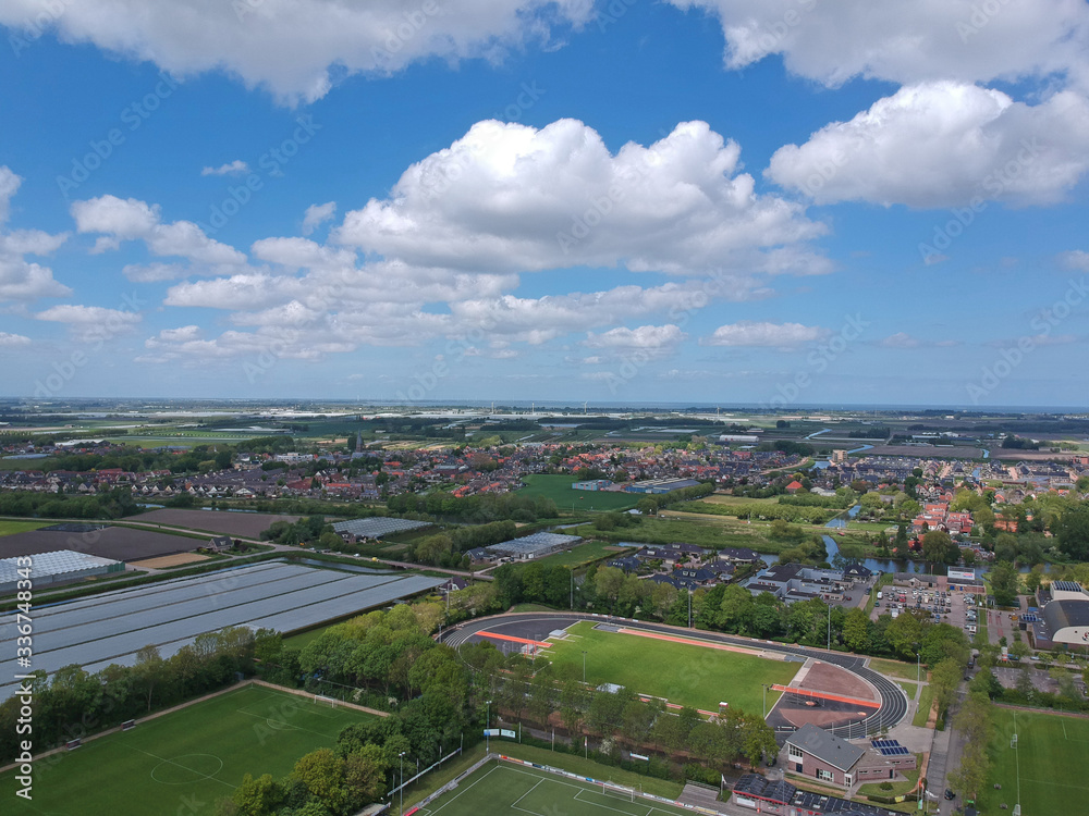  Drone Aerial view of soccer fields and the buildings of the village of Grootebroek, which is part of urban planning. Photo make with a drone 
