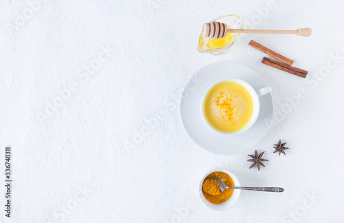 Top view image of turmeric latte over white table with copy space