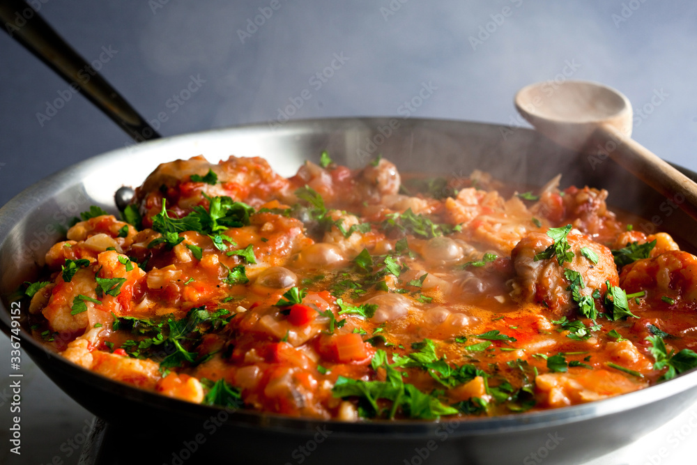 Greek chicken stew with cauliflower and olives on skillet Greek chicken stew with cauliflower and olives on skillet