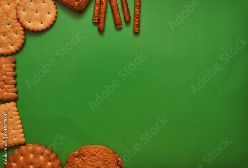 composition biscuits and almonds on a green background lay flat left side photo