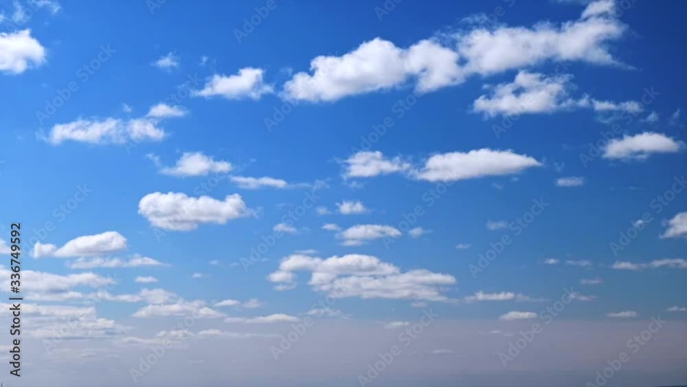 Timelapse with fast-running fluffy tiny white clouds on bright blue sky on a sunny summer day. 4K Time lapse puffy cloudy blue sky. Pattern of clouds in the sky. Texture. Nature. Air Timelapse with fast-running fluffy tiny white clouds on bright blue sky on a sunny summer day. 4K Time lapse puffy cloudy blue sky. Pattern of clouds in the sky. Texture. Nature. Air