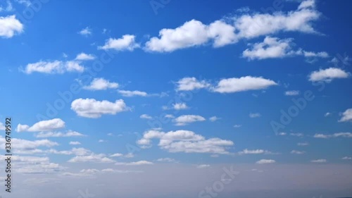 Timelapse with fast-running fluffy tiny white clouds on bright blue sky on a sunny summer day. 4K Time lapse puffy cloudy blue sky. Pattern of clouds in the sky. Texture. Nature. Air