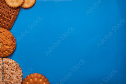 composition biscuits and almonds on a bluebackground lay flat photo