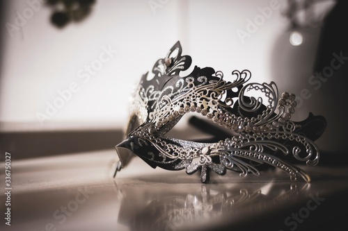 A scenic portrait of a mysterious venetian mask lit by a window. A great way to hide your identity on a masked ball, carnival or halloween party.