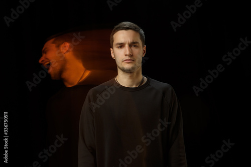 Cold outside, laughting inside. The versatility of man - opened emotions and hidden feelings. Caucasian man on black background with different faces of condition. Double exposure. Mental health.