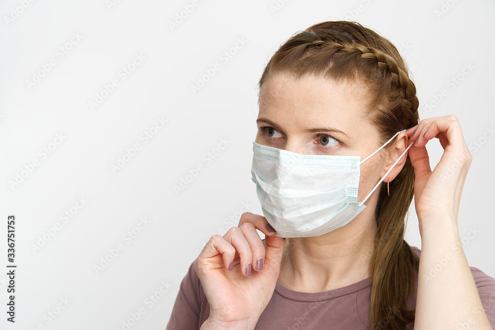 woman wearing medical mask. Masked woman - protection against influenza virus. ear with protective face surgical mask at home. Stop the virus and epidemic diseases. stop coronavirus. woman wearing medical mask. Masked woman - protection against influenza virus. ear with protective face surgical mask at home. Stop the virus and epidemic diseases. stop coronavirus.