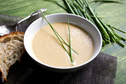 Bowl of creamy leek soup with chives photo