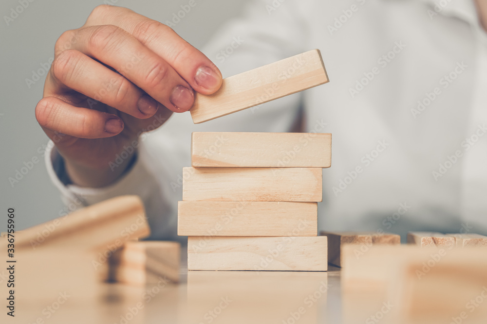 Successful business concept - hand holds wooden blocks.