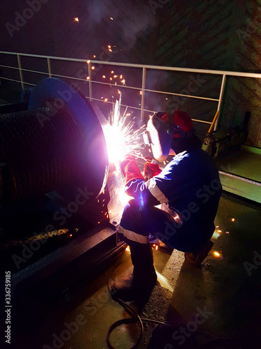 Welder working on a ship winche