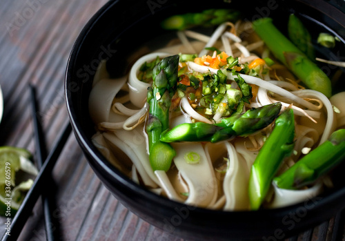Close up of vegetarian Pho with asparagus and noodles