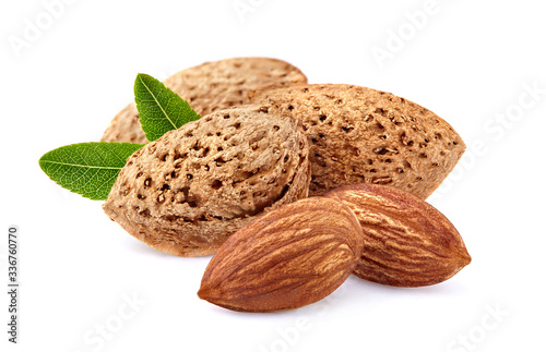 Almonds with leaves in closeup isolated on white background.