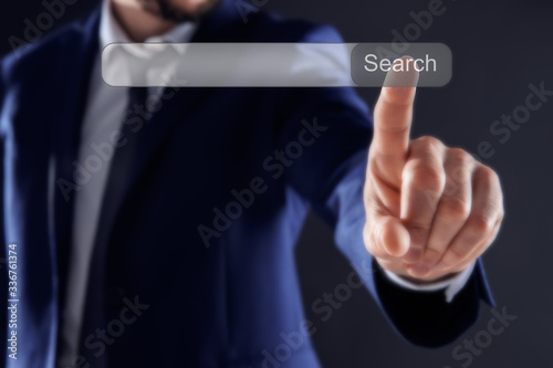 Businessman using search bar on virtual screen, closeup