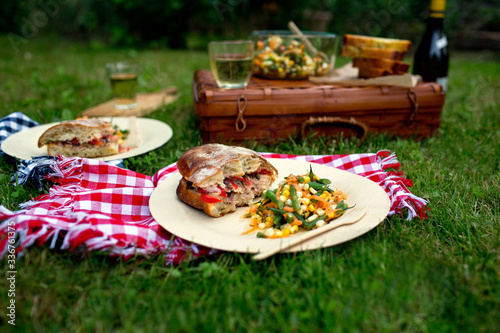 Picnic with pan bagnat, haricots verts, corn and carrot salad photo