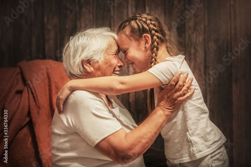 Konstfotografi grandmother plays with her granddaughter, depict a plane, hug, time with relativ