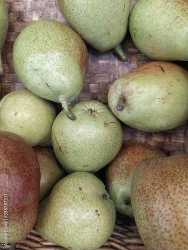 Fresh red pears on the shelves of the market