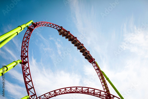 Fototapeta Naklejka Na Ścianę i Meble -  Rollercoaster large loops in an amusement park. Summer panorama. Copy space.