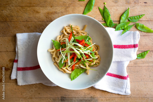 Overhead view of cold sesame noodles with crunchy vegetables