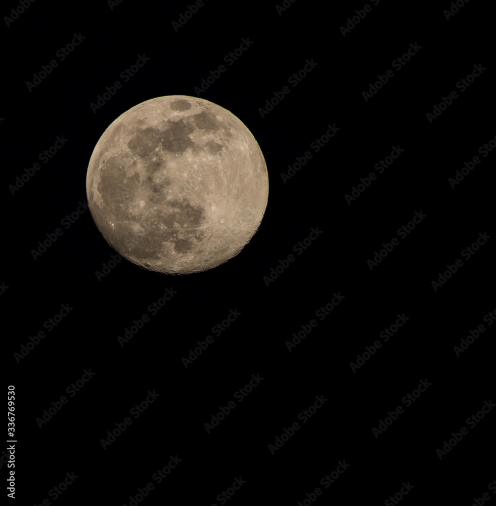 Natural full moon close up with dark sky background Natural full moon close up with dark sky background