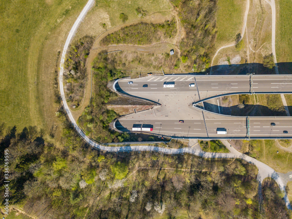 Aerial view of highway tunnel in spring landscape. Concept of traffic through mountain.