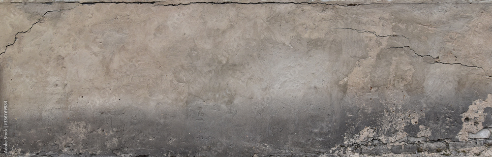 A gray plastered wall with a crumbling dirty texture A gray plastered wall with a crumbling dirty texture