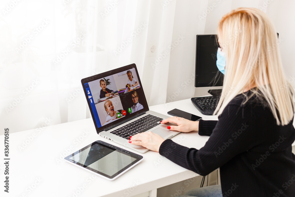 Young woman wearing protective gloves on hands and mask on face working from home or at office work by the laptop video call preventing virus spread epidemic quarantine prevention Young woman wearing protective gloves on hands and mask on face working from home or at office work by the laptop video call preventing virus spread epidemic quarantine prevention
