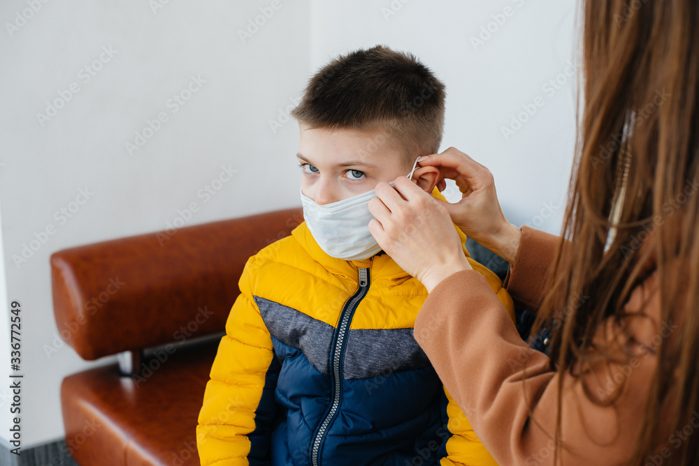 A mother with her child stands in a mask during the quarantine. Pandemic, coronavirus A mother with her child stands in a mask during the quarantine. Pandemic, coronavirus