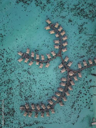 Aerial view on luxury hotel bungalows villas on water Moorea in French Polynesia by drone 