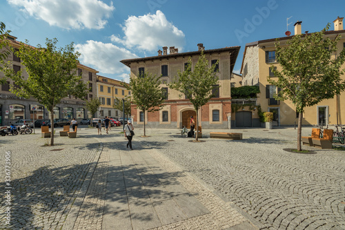 Como, ITALY - August 4, 2019: Local people and tourists on a quiet cozy streets in the center of beautiful Italian Como city. Warm sunny summer day in very popular holiday destination © Yury