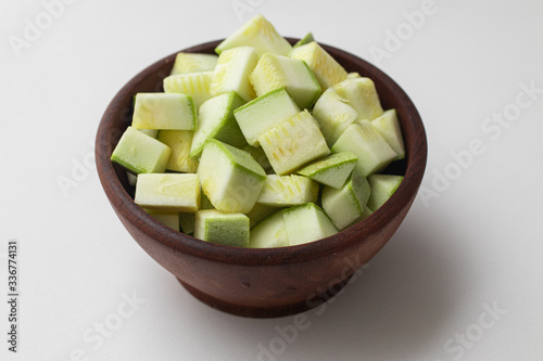 Diced Zucchini into a wooden bowl