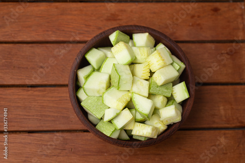 Diced Zucchini into a wooden bowl