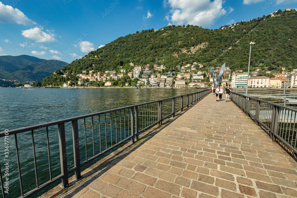 Obraz premium Como, ITALY - August 4, 2019: Marina in the Lake Como in the center of beautiful Italian Como city. Warm sunny summer day in very popular holiday destination