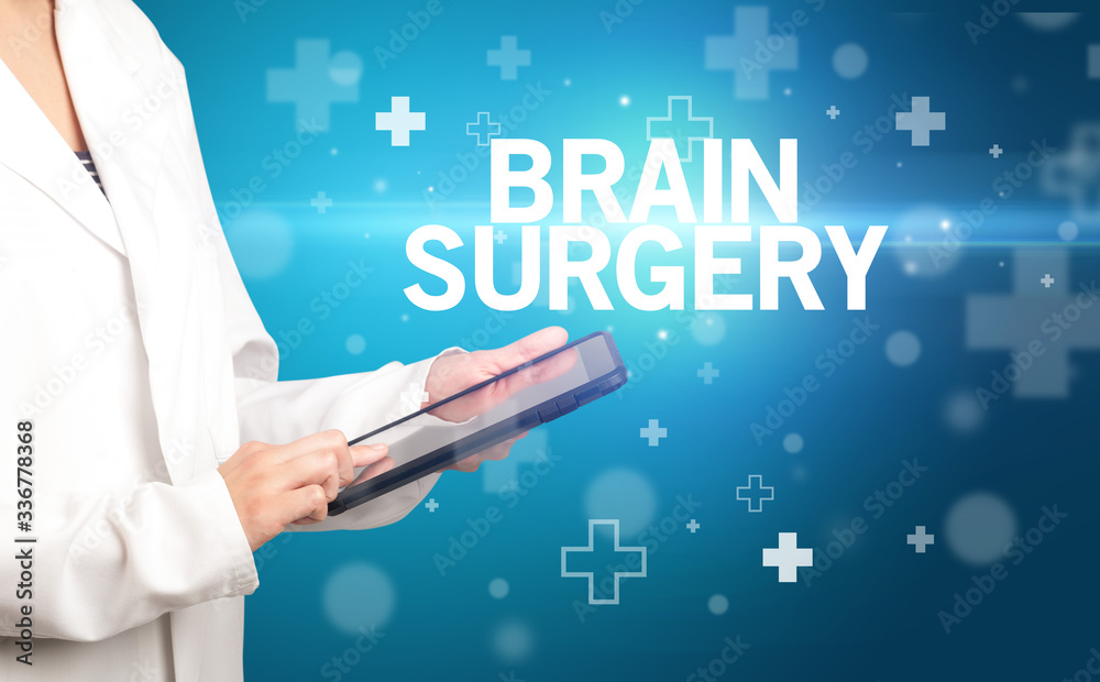 doctor writes notes on the clipboard with BRAIN SURGERY inscription, first aid concept doctor writes notes on the clipboard with BRAIN SURGERY inscription, first aid concept