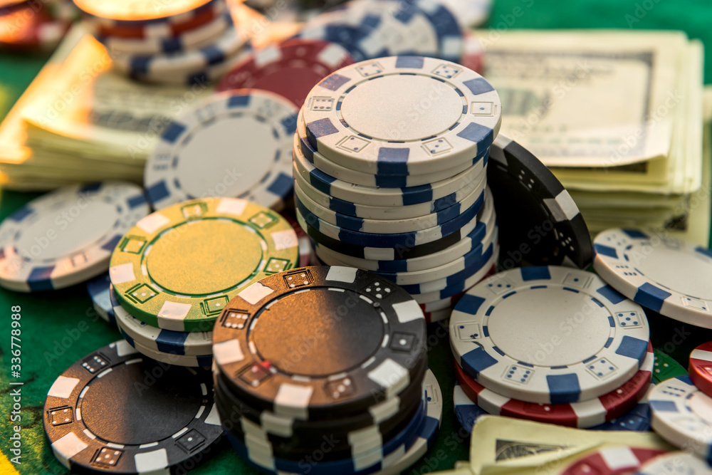 Casino chips with dollar bills on green poker table. Risk or win Casino chips with dollar bills on green poker table. Risk or win
