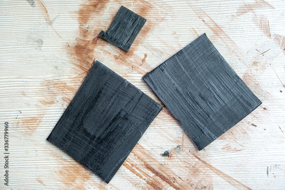 Working surface of the Shoe repair shop. There are rubber patches on the table. stick patch on the damaged surface of the leather product Working surface of the Shoe repair shop. There are rubber patches on the table. stick patch on the damaged surface of the leather product