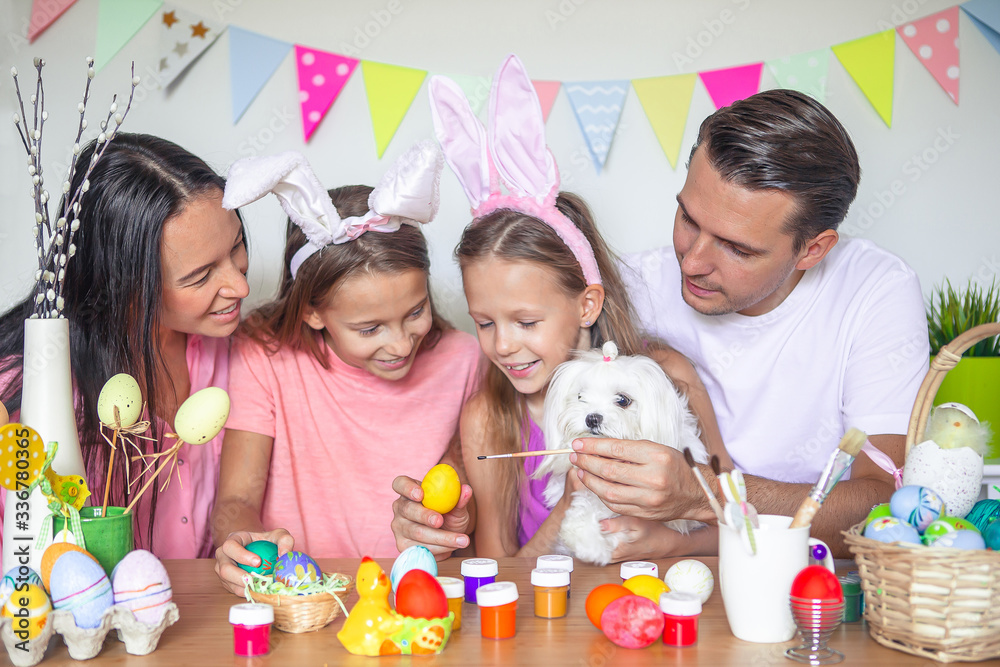 Mother and her little daughter painting eggs. Happy family preparing for Easter. Mother and her little daughter painting eggs. Happy family preparing for Easter.