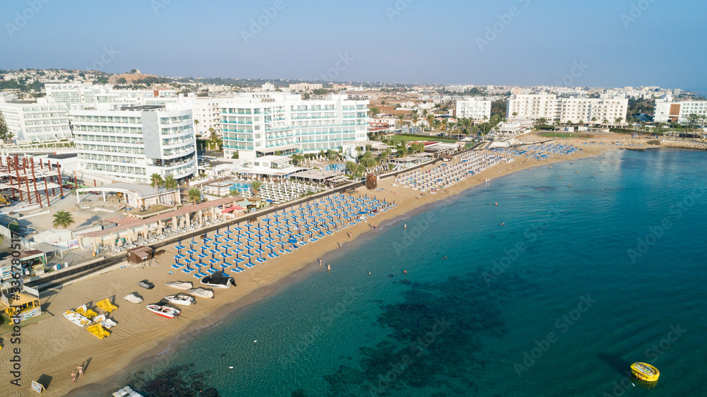 Aerial bird's eye view of Sunrise beach Fig tree, Protaras, Paralimni, Famagusta, Cyprus.The famous tourist attraction family bay with golden sand, boats, sunbeds, restaurants, water sports from above