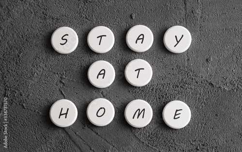 Stay at home message collected with pills on dark background. photo