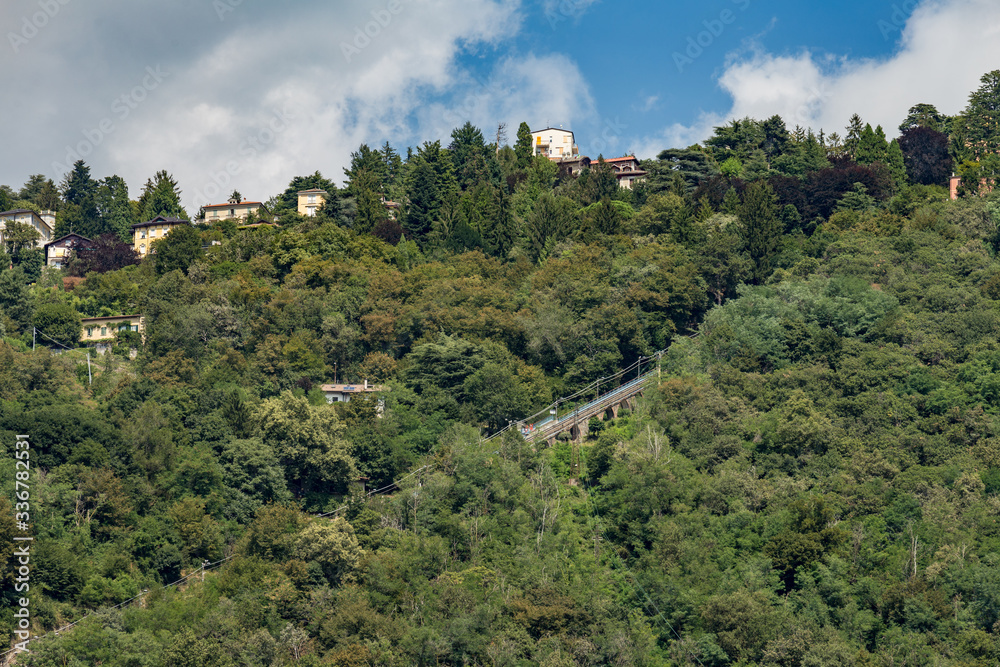 custom made wallpaper toronto digitalComo, ITALY - August 4, 2019: Apartments, villas, hotels on the green forested mountainsides near Lake Como. Beautiful Italian Como city. Warm sunny summer day in very popular holiday destination