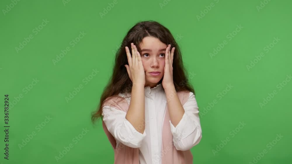 All my fault! Upset teenage brunette girl in white shirt gesturing facepalm with hand on forehead, feeling sorrow and shame about mistake, blaming herself. studio shot isolated on green background All my fault! Upset teenage brunette girl in white shirt gesturing facepalm with hand on forehead, feeling sorrow and shame about mistake, blaming herself. studio shot isolated on green background