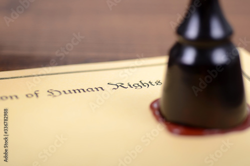 Universal Declaration of Human Rights, Scales of Justice and  Notary seal on the wooden background. photo